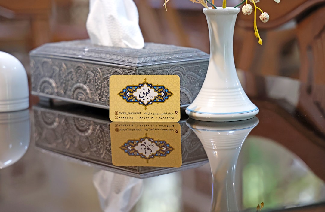 services-img a-golden-business-card-with-ornate-design-sits-on-table-rqbasan2yqq